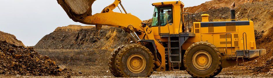 Wheel loader grading and moving dirt