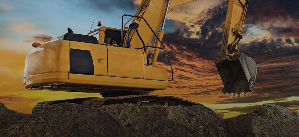Excavator working a job site at golden hour