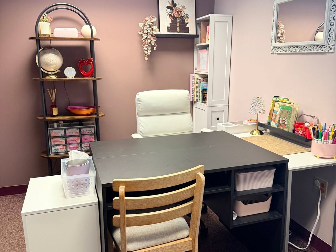 The one-to-one desk at CoreLogic Learning, set for a single student with book bins and supplies within reach