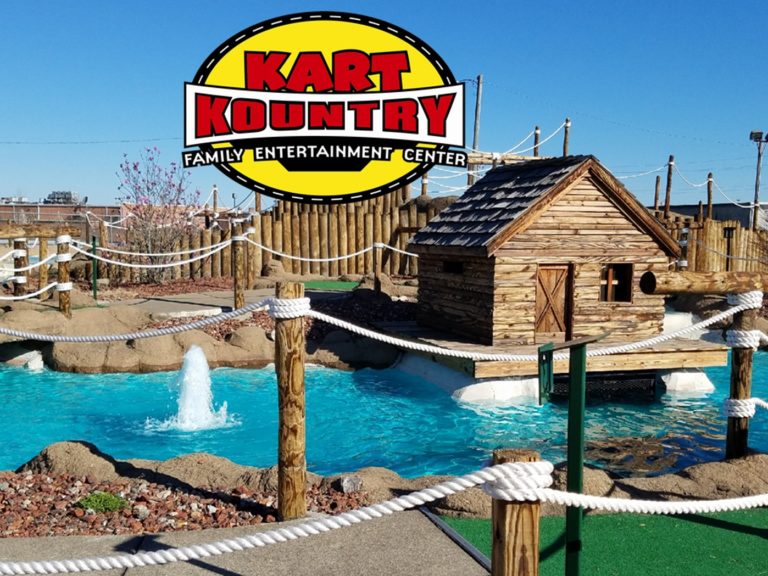 The Volcano miniature golf course with a log cabin and fountain