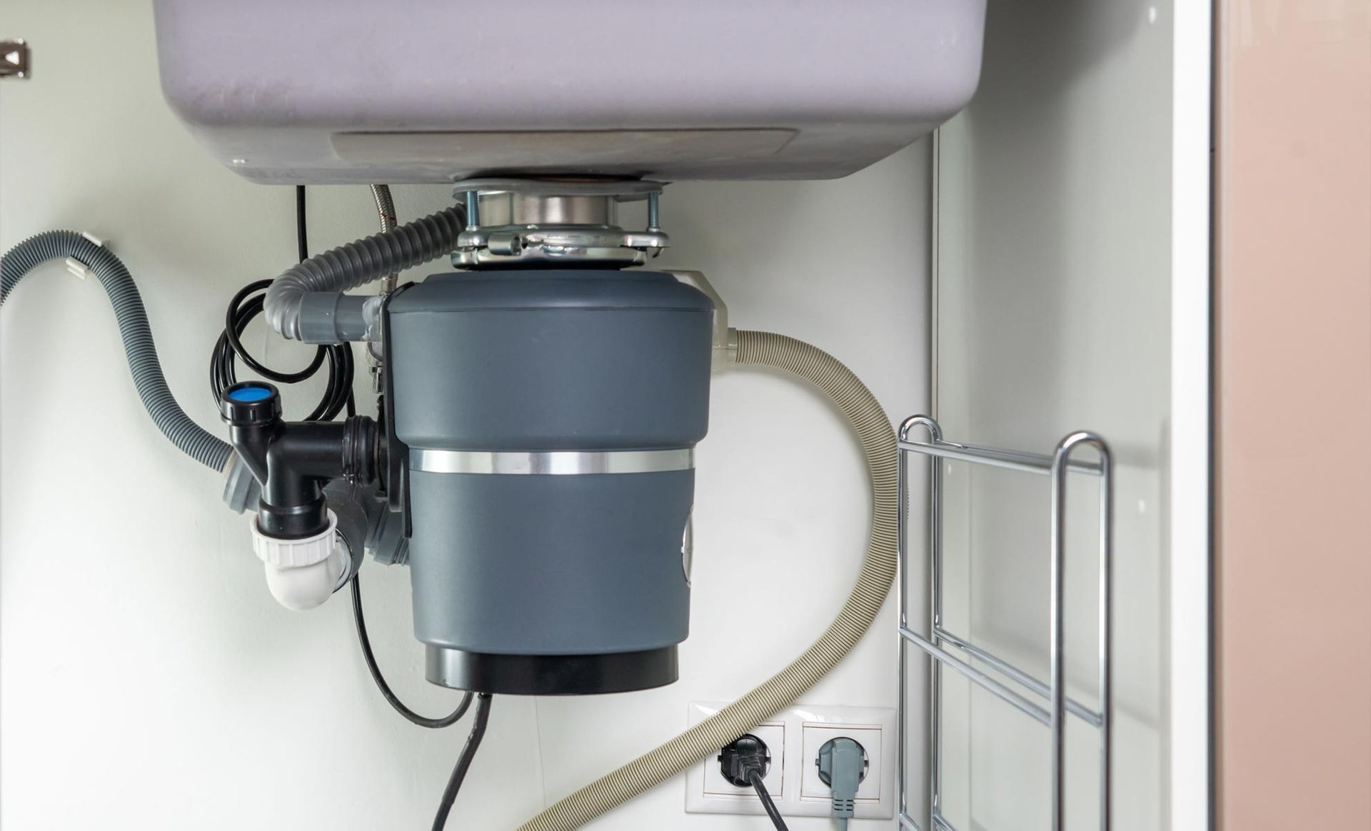 Under-sink plumbing where a garbage disposal is serviced