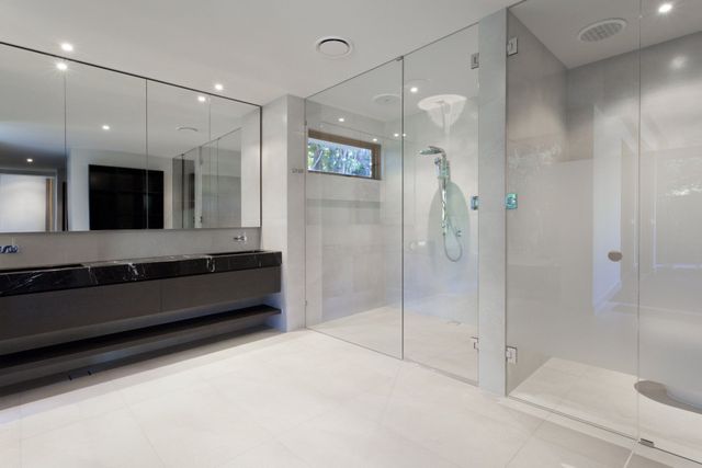 Frameless shower enclosure