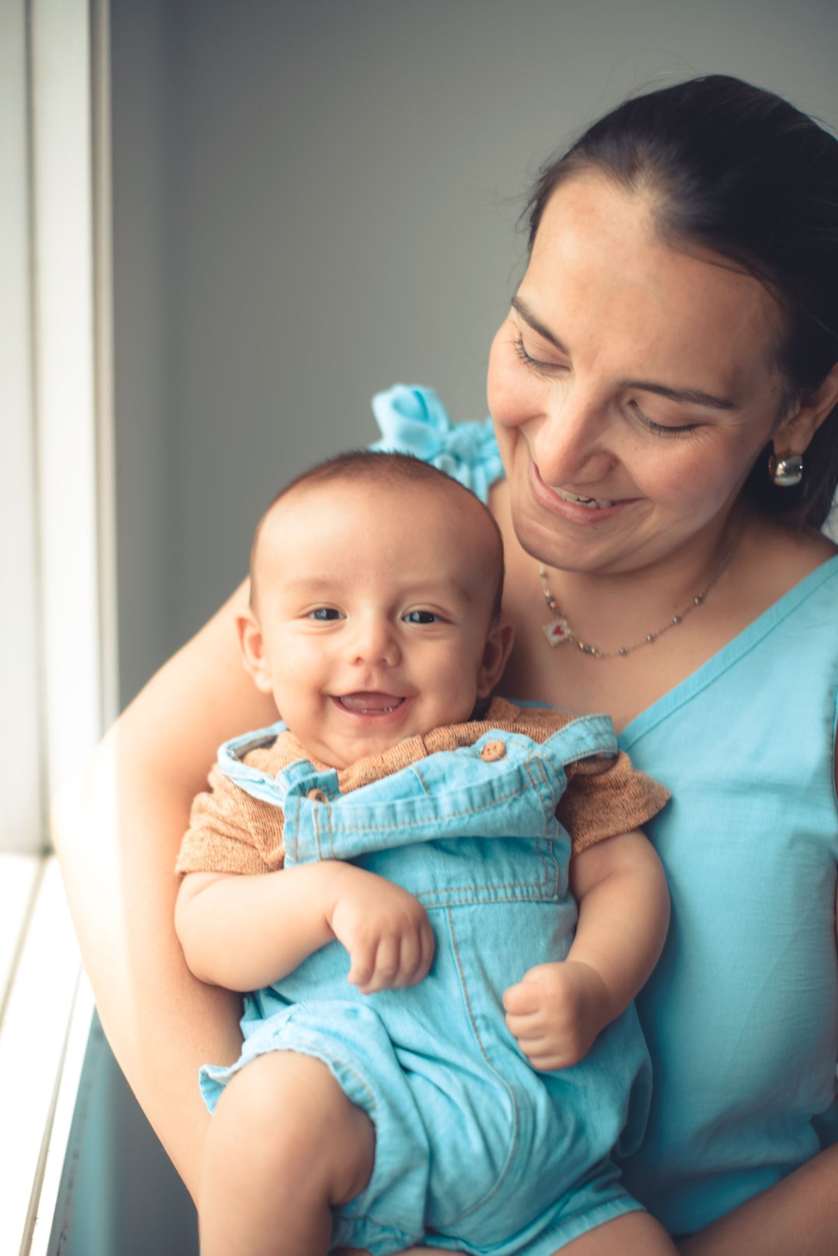A mother holding her smiling baby