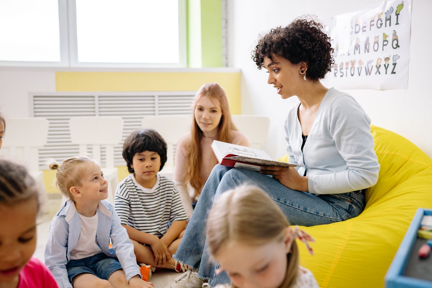 A teacher reading with children at River Ridge