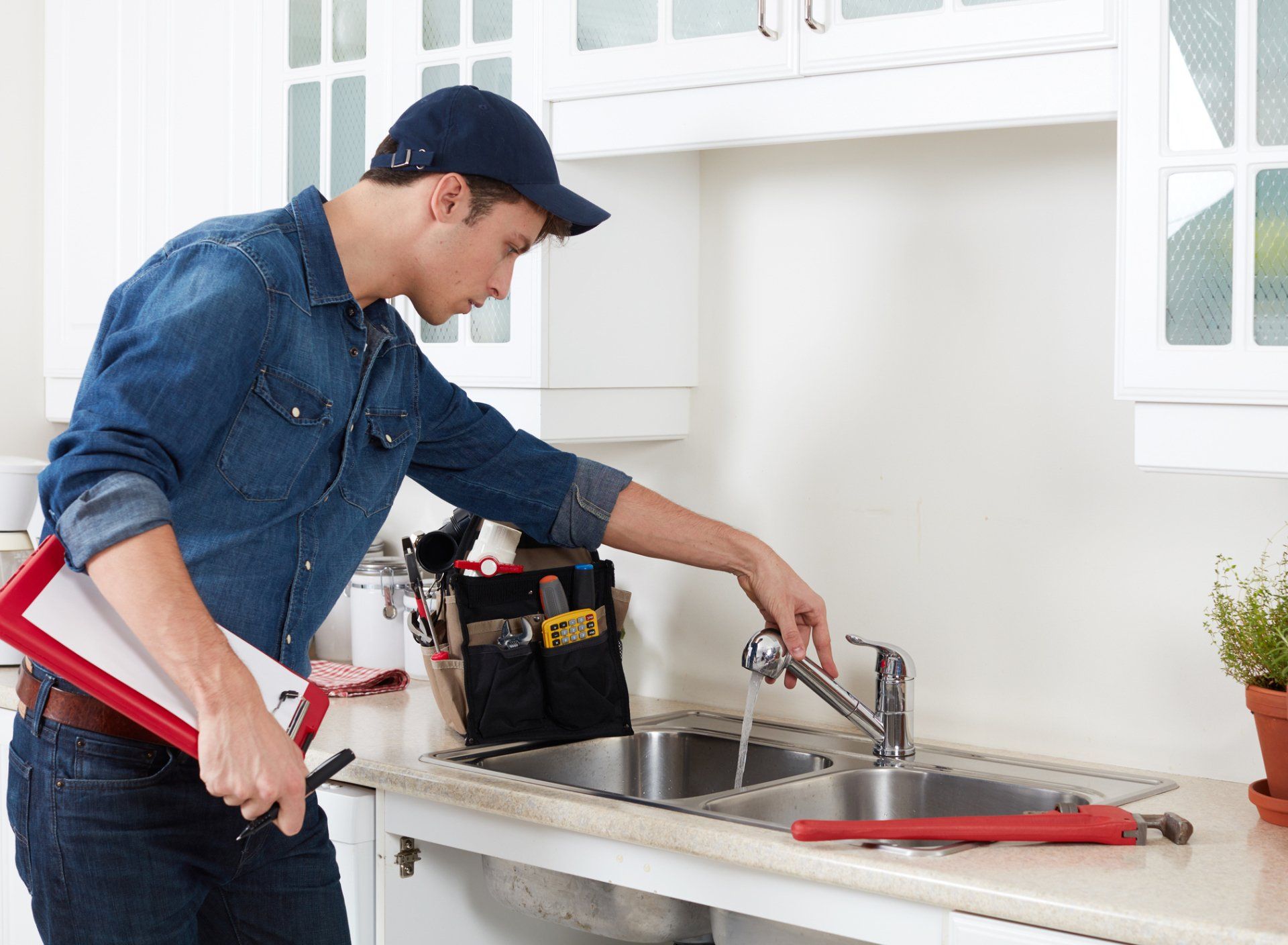 Southern Plumbing plumber inspecting and testing a kitchen sink