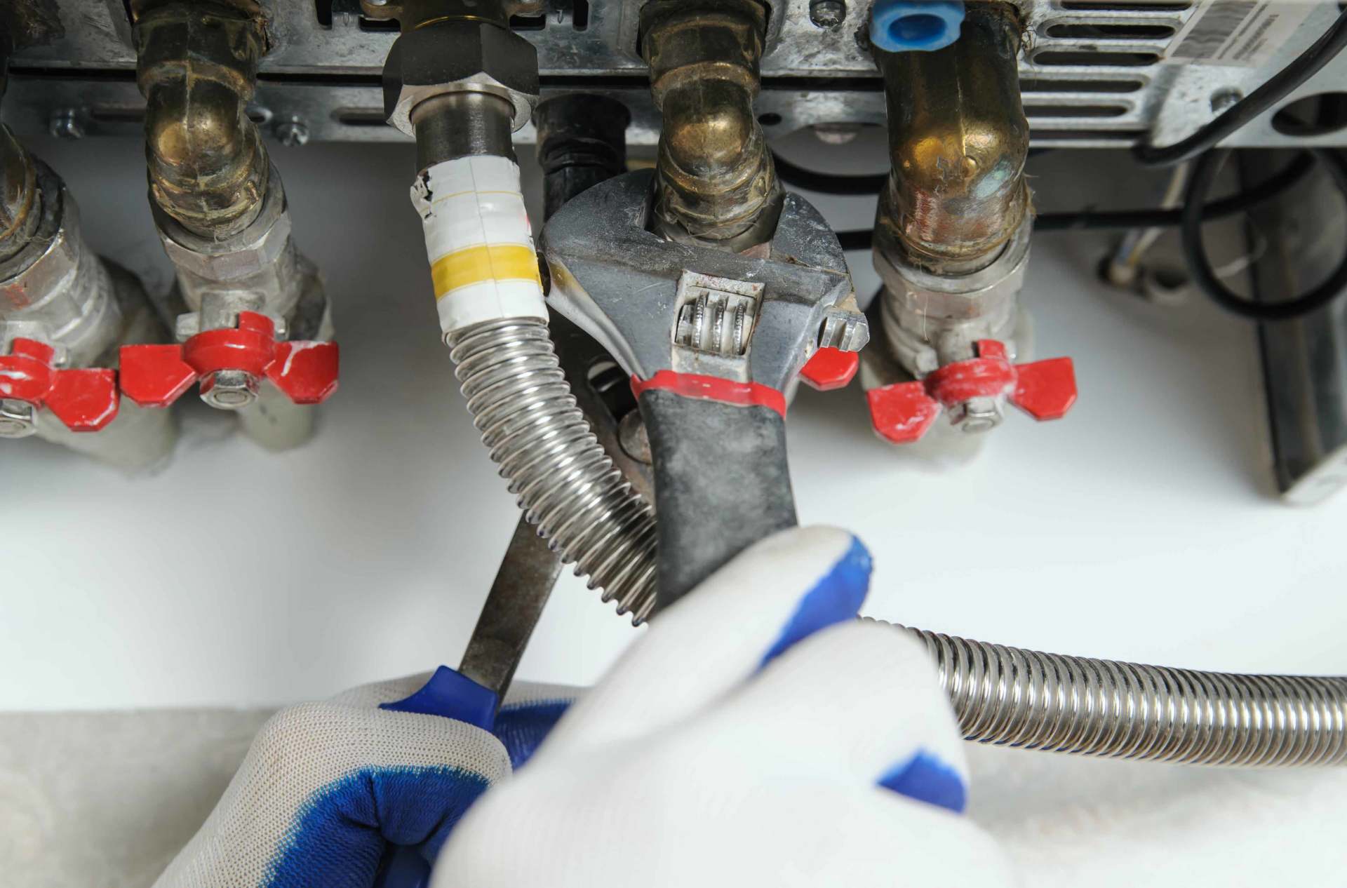 Adjustable wrench on brass commercial pipe fittings and valves